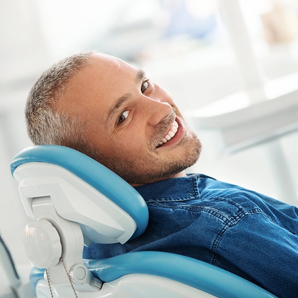 A mature man with dental implants smiling